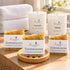 Sanfte Auszeit – Ruhige Momente von Friesenzart mit 3 × Naturseife Sommersonne, 1 × Duftkerze Weite, 1 × Duftkerze Auszeit, 1 × Holzschale rund, 2 × Handtuch Weiß. Beispielkombination; jede Kerzenglasfarbe unabhängig frei wählbar.